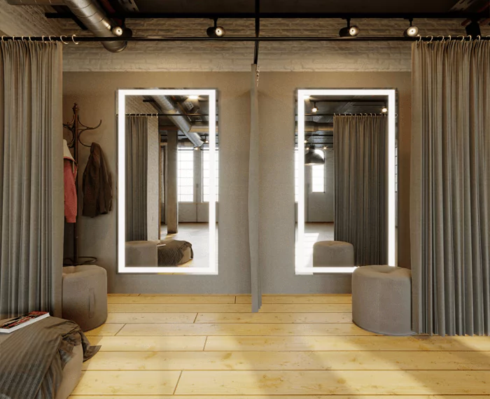 Two light-integrated mirrors embedded in a wall with brown curtains and two round chairs.