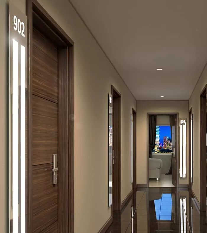 Hotel hallway with light strips near each hardwood door.